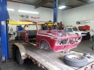 Stage 1 of restoration: the shell arrives on a flatbed trailer